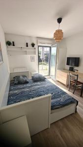 a bedroom with a large bed in a room at CHROMA - Studio Nantes GARE SUD in Nantes +14 photos