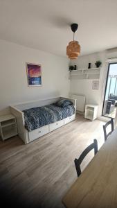 a bedroom with a bed in the middle of a room at CHROMA - Studio Nantes GARE SUD in Nantes