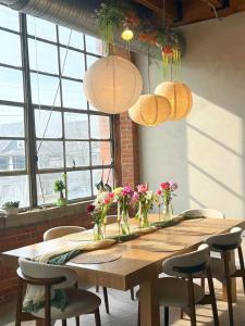 a wooden table with chairs and flowers in vases at Charming Urban Zen in Cleveland