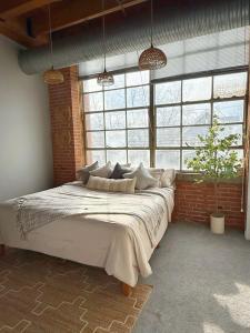 a bedroom with a large bed in front of a window at Charming Urban Zen in Cleveland +7 photos