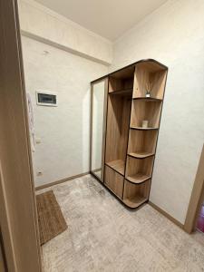 a room with a wooden cabinet in the corner at New House Strișca in Chişinău
