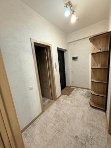 an empty room with two doors and a hallway at New House Strișca in Chişinău +3 photos