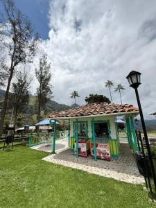 a small building in a park with a street light at Refugio Nidos del Condor Cocora in Salento