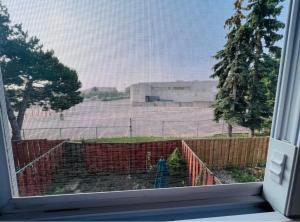 a window with a view of a fence at ComfyRoom in Toronto