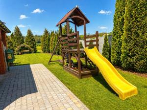 a playground with a slide and a gazebo at Willa Fenix Busko-Zdroj Pokoje Goscinne & Agroturystyka in Busko-Zdrój