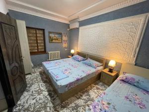a bedroom with two beds and two lamps in it at LION Guest House in Bukhara +77 photos