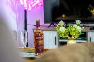 a bottle of wine on a table with a glass at Assinie's apartment in Assinie +16 photos