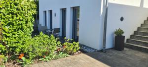a house with stairs and flowers in a yard at Spessartblick Eisingen in Eisingen