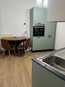 a kitchen with a table with chairs and a sink at Sotto la Cupola in Montefiascone +11 photos