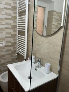 a bathroom with a sink and a mirror at Sotto la Cupola in Montefiascone