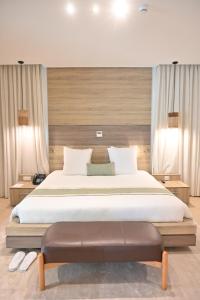 a bedroom with a large bed and a bench in it at BBr in Jacqueville