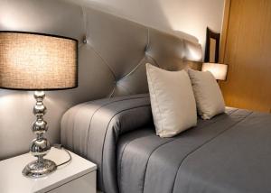 a bedroom with a bed with a headboard and a lamp at El Respiro in Ruidera +27 photos