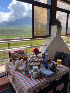 a table with a plate of food on it with a view at Olea Azul in Chefchaouen