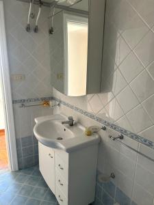 a bathroom with a white sink and a mirror at Casa Vacanze Anema & Core in Agerola