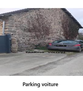 a car parked in front of a stone building at Bourlidou in Combourg