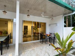 a patio with a table and chairs and a dining room at Vegas Luxe Thoddoo in Thoddoo