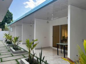 an external view of a house with a table on a patio at Vegas Luxe Thoddoo in Thoddoo +6 photos