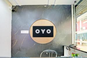 a wall with an ovo sign on it at Hotel O Tanatan Premium in Bhopal