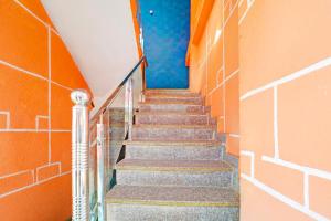 a stairway leading up to a pool in a building at Hotel O Tanatan Premium in Bhopal