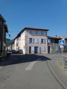an old stone building on the side of a street at Maison de village commingeoise in Miramont-de-Comminges
