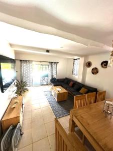 a living room with a couch and a table at Diani Hideaway Beach Villa, private pool, air conditioning and WiFi in Galu