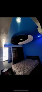 a blue bedroom with a bed and a blue ceiling at Casa Cristian in Caracas +5 photos