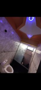 a bathroom with a toilet with a star on the ceiling at Casa Cristian in Caracas