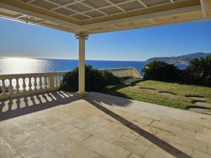 a porch with a view of the ocean from a house at Mare e Relax - La Villetta ai Tre Ponti - Trilocale in Sanremo