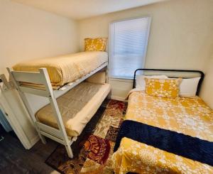 a small room with two bunk beds and a window at Wishon Cabin - Boat Slip - BBQ, Sleeps 14, Dogs Ok in The Pines