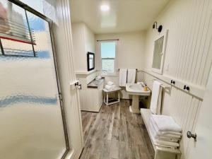 a bathroom with a shower and a sink at Wishon Cabin - Boat Slip - BBQ, Sleeps 14, Dogs Ok in The Pines +9 photos