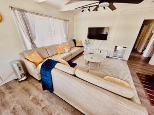 a living room with a couch and a table at Wishon Cabin - Boat Slip - BBQ, Sleeps 14, Dogs Ok in The Pines