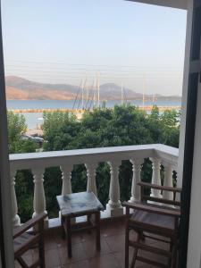 a balcony with two chairs and a view of the ocean at Karyatis studios lixouri in Lixouri +1 photo