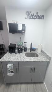 a kitchen counter with a sink and a phone at DC lodging LLC in Tampa
