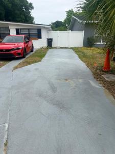 a driveway with a car parked in front of a house at DC lodging LLC in Tampa