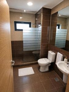 a bathroom with a toilet and a sink at HF - Mamaia Nord in Mamaia Sat/Năvodari +16 photos