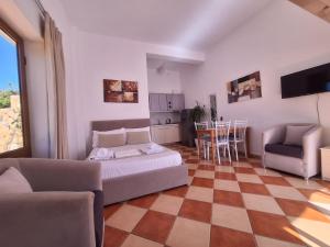 a living room with a couch and a table and chairs at Mermaid Hotel Vlore in Vlorë