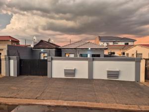 a white garage in front of a bunch of houses at Masakwe BNB in Soweto