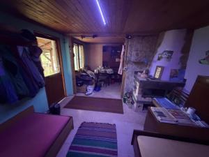 a small room with a living room with a table at Kazanlak SHELTER HOUSE ACCOMODATION 1 Room 1 Bed, No Water, WC is Outhouse, Dirt Road, Dog in the Garden, Genius Points Welcome! Къща за Подслон в Казанлък, Без Вода! in Kazanlŭk