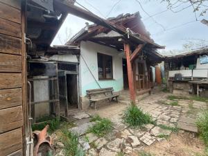 an old house with a bench in front of it at Kazanlak SHELTER HOUSE ACCOMODATION 1 Room 1 Bed, No Water, WC is Outhouse, Dirt Road, Dog in the Garden, Genius Points Welcome! Къща за Подслон в Казанлък, Без Вода! in Kazanlŭk