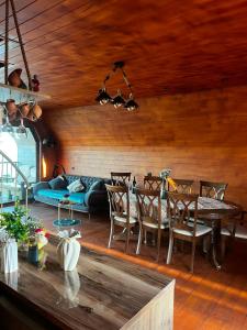 a living room with a couch and a table at Nakas cottage in Tbilisi City