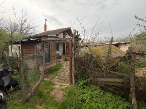 an old house with a fence in front of it at Kazanlak SHELTER HOUSE ACCOMODATION 1 Room 1 Bed, No Water, WC is Outhouse, Dirt Road, Dog in the Garden, Genius Points Welcome! Къща за Подслон в Казанлък, Без Вода! in Kazanlŭk