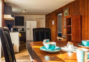 a kitchen and dining room with a wooden table with blue bowls at GpL 3321 Downtown Fort Myers Retreat in Fort Myers
