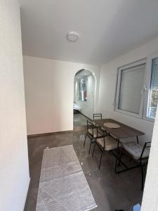 a dining room with a table and chairs in a room at Stan na dan Berane in Berane