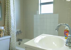 a white bathroom with a sink and a shower at GpL 3321 Downtown Fort Myers Retreat in Fort Myers +11 photos