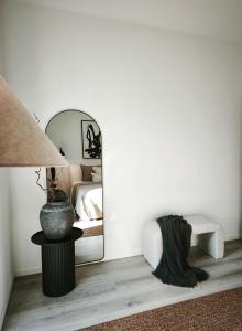 a bedroom with a bed and a mirror at Vila Karup Modern Scandinavian Holiday Home in Båstad