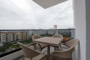 a table and chairs on a balcony with a view at Crown Apartments in Golem