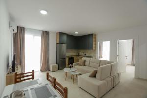 a living room with a couch and a table at Crown Apartments in Golem