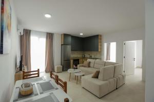 a living room with a couch and a table at Crown Apartments in Golem