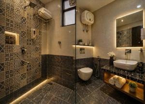 a bathroom with a toilet and a sink and a shower at Hotel Belwood De Near Delhi Airport IGI in New Delhi