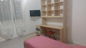 a bedroom with a desk and a bed and a desk and shelf at B&B Montegrappa in Mestrino